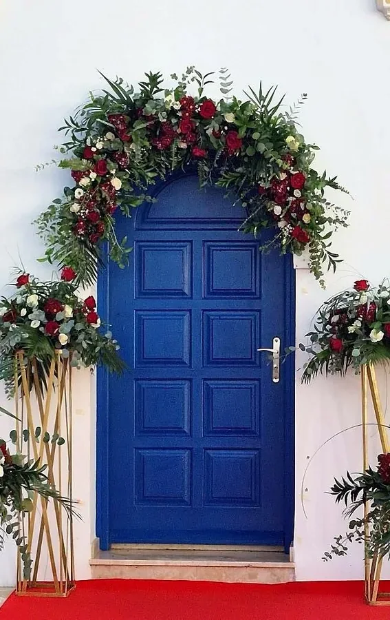 Ceremony arch at a blue door